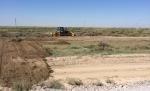 Photo No.2 Planning of earth outside of borders of construction camp at section SP 1115+00-SP1125+00 on left lane of the road